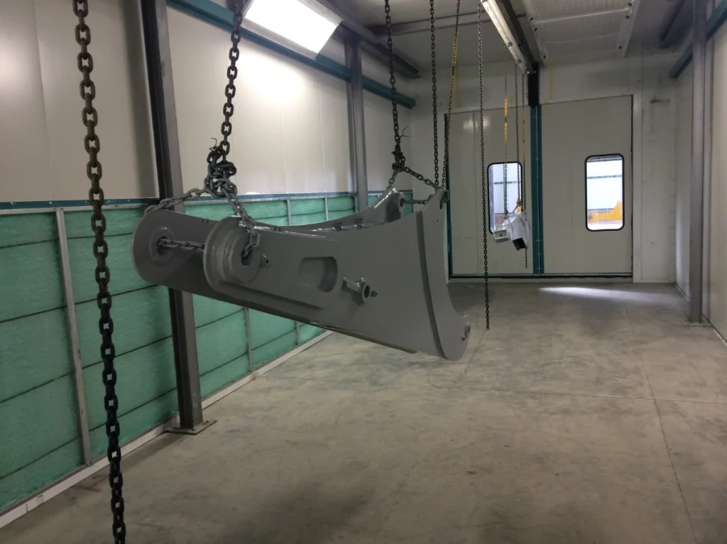 conveyorized Gas-fired curing oven for heavy-duty excavator components.